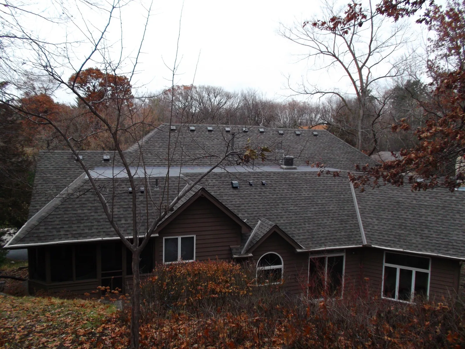 Large residential property with complex low-slope roofline in Ham Lake, MN. Northern Forge Construction flat and TPO roofing services in Anoka County and the north Minneapolis metro