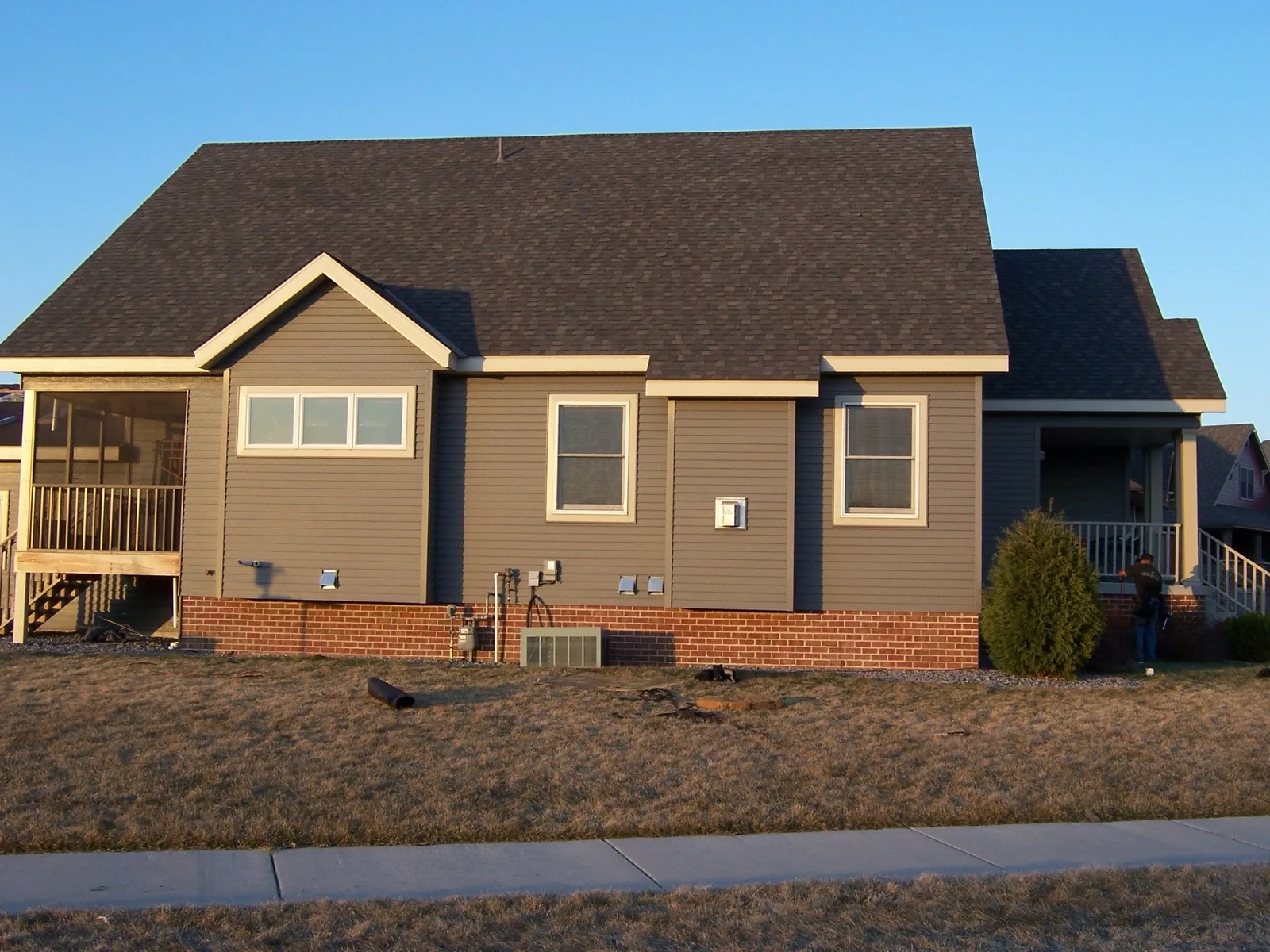 Completed gray LP siding and dark asphalt shingle roof on ranch-style home in Lino Lakes, MN. Northern Forge Construction